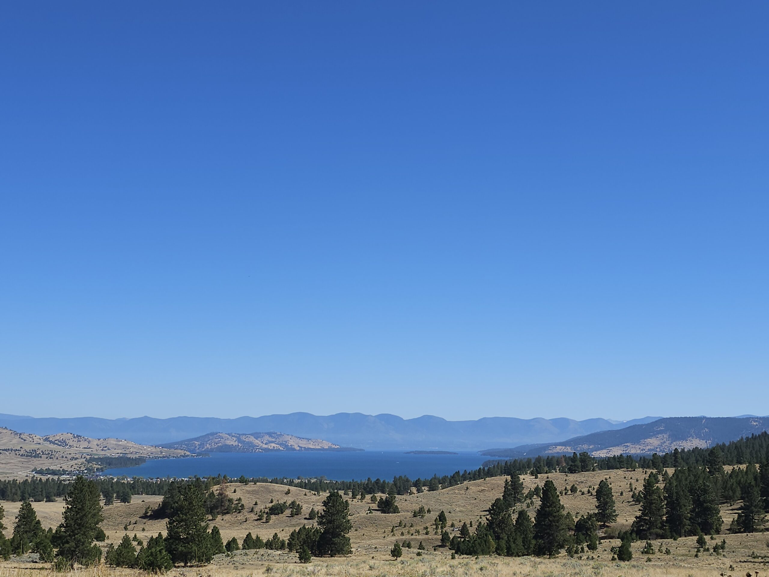 Beautiful scenic overlook in Lake Coeur d’Alene with mountain peaks and clear water reflections