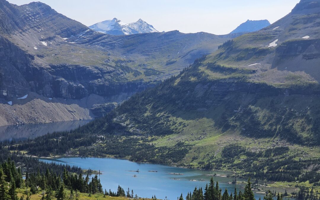 Hidden Lake in Glacier National Park with mountain peaks and clear water reflections