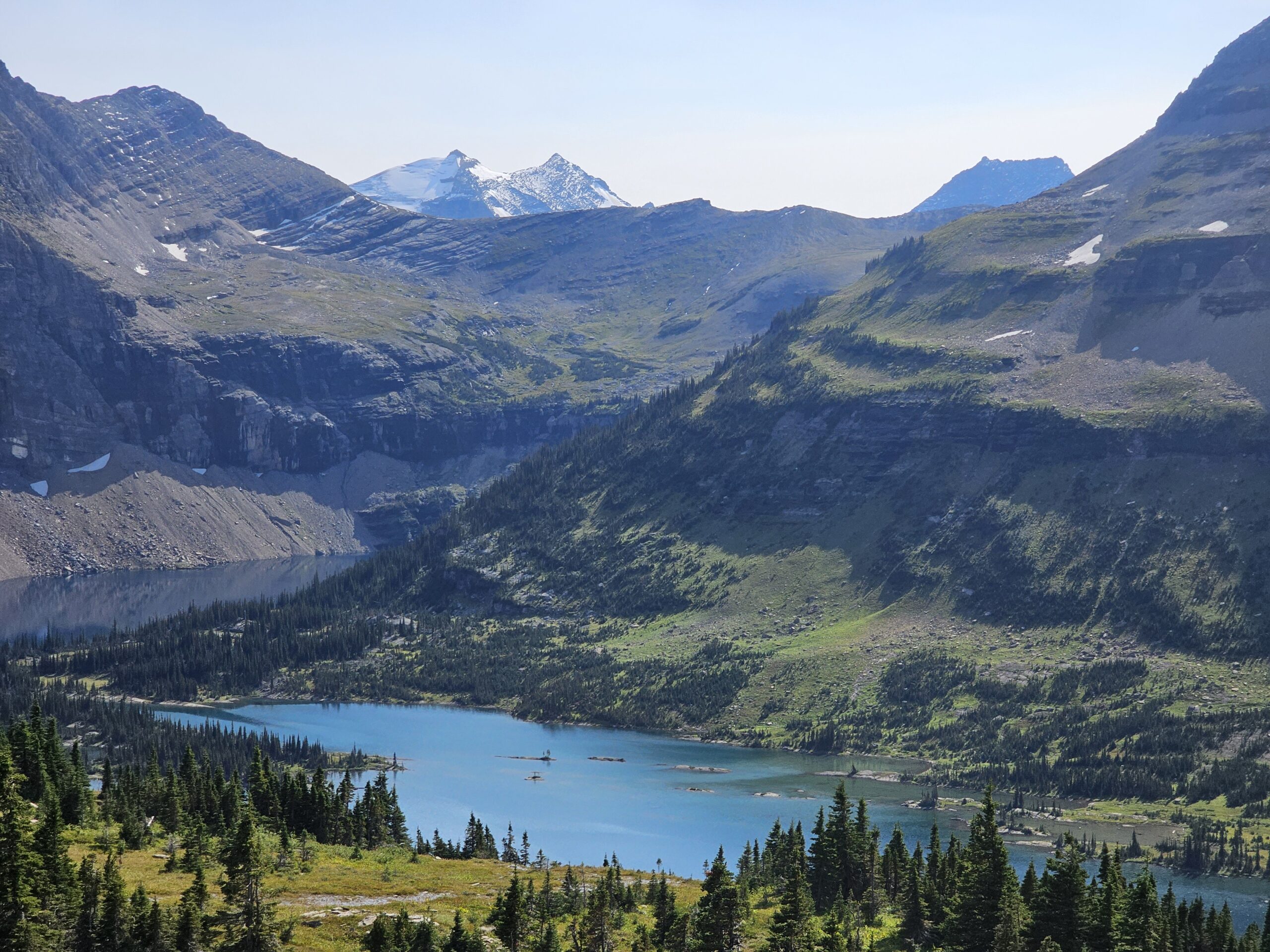 Hidden Lake in Glacier National Park with mountain peaks and clear water reflections